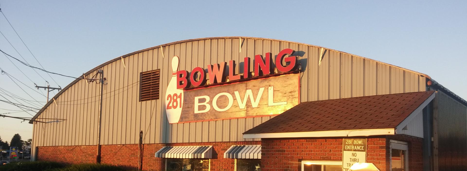 The 281 Bowl building at golden hour with its red neon BOWLING sign lit up