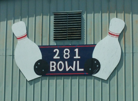The hand-painted 281 Bowl sign with two bowling pins in daylight